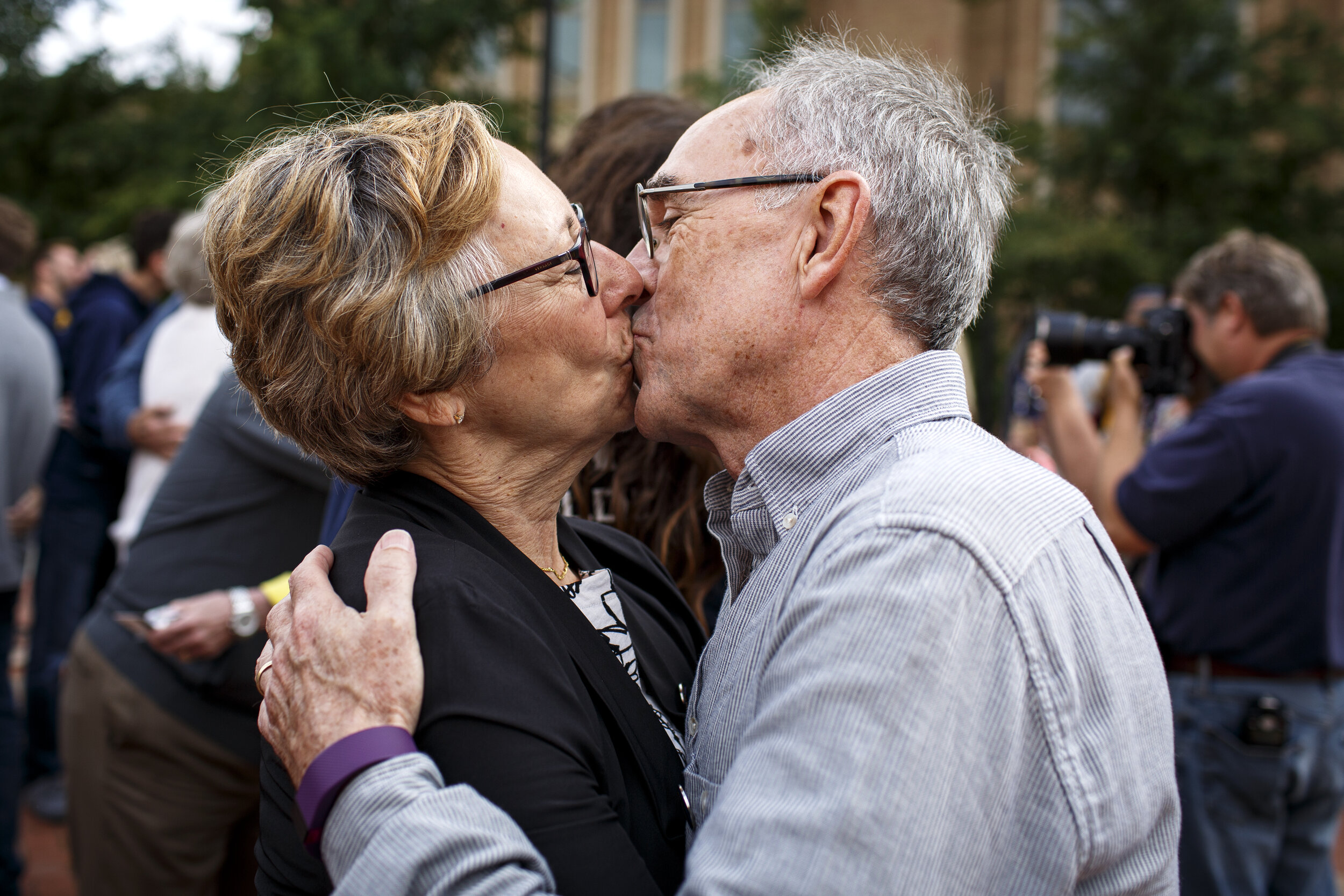  Roderick “Rick” Anstey, a Kent State class of ‘68 alumn, and his wife Francine “Cini” Anstey, a class of ’69 alum, kiss each other during the “Kiss on the K” Homecoming event on Saturday, Oct. 1, 2016 