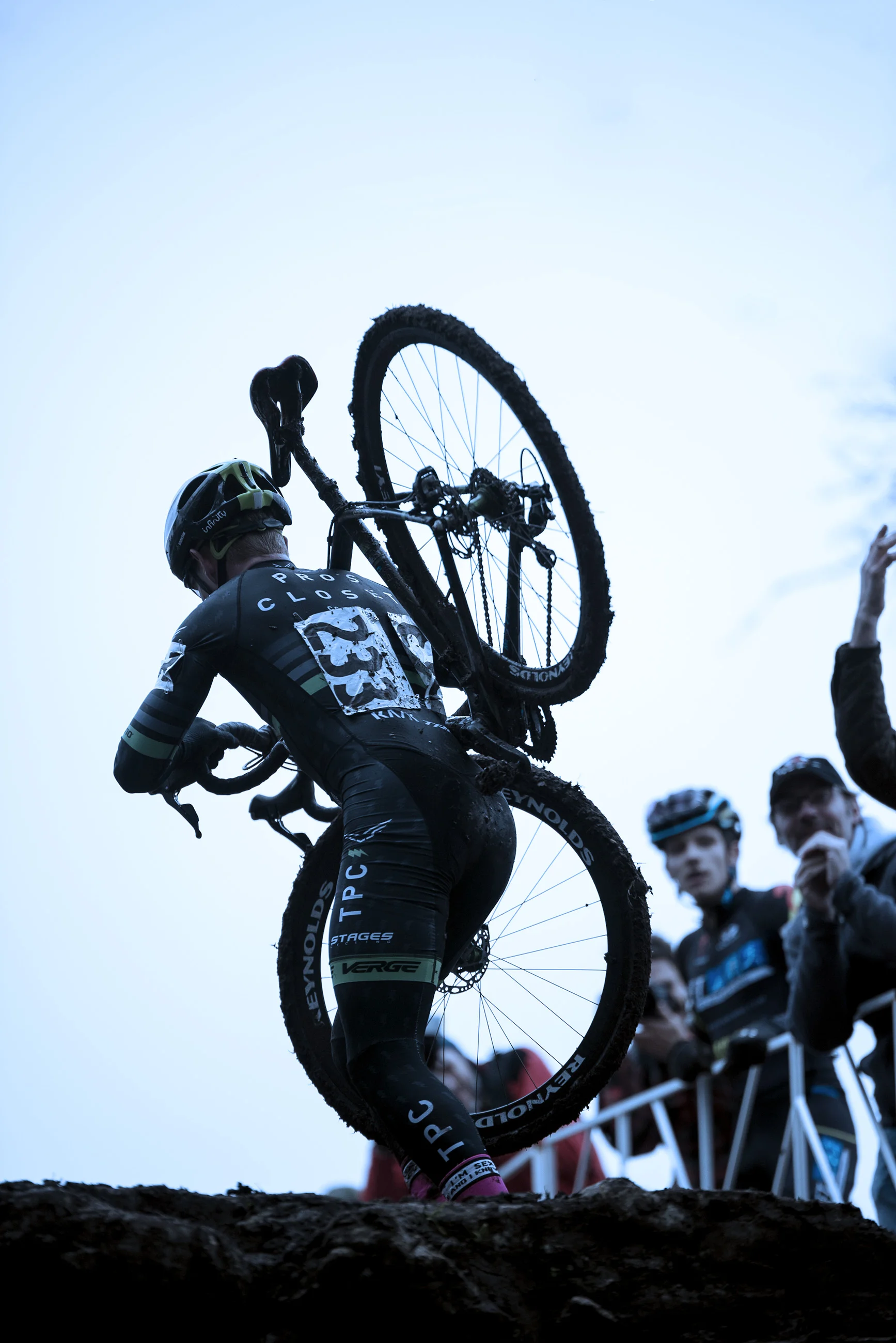 Cyclocross rider carries bike up hill