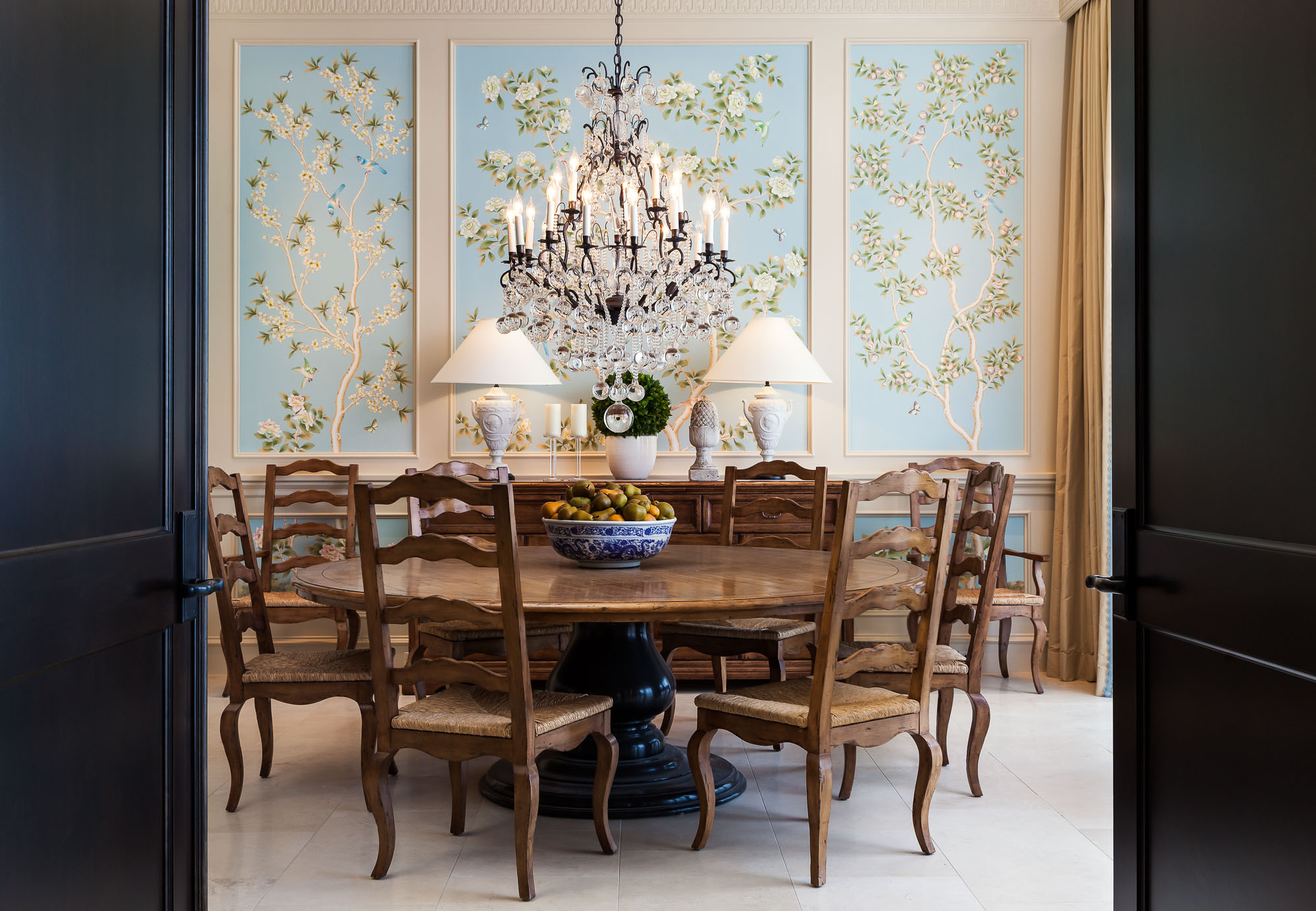 Luxury penthouse dining room in Pasadena, California with elegant chandelier, wooden dining table, and ornate wall decor.