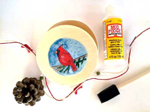 These balsa wood boxes come in all shapes and sizes. They are very light and natural looking and take acrylic paint. Markers tend to bleed a little so you may want to buy one as a tester to experiment with different mediums. I like to add decorative ribbon around the edge for a little extra pop. I bet a nice home made ornament wrapped in some sparkly tissue paper would make a great gift, just to give you an idea!