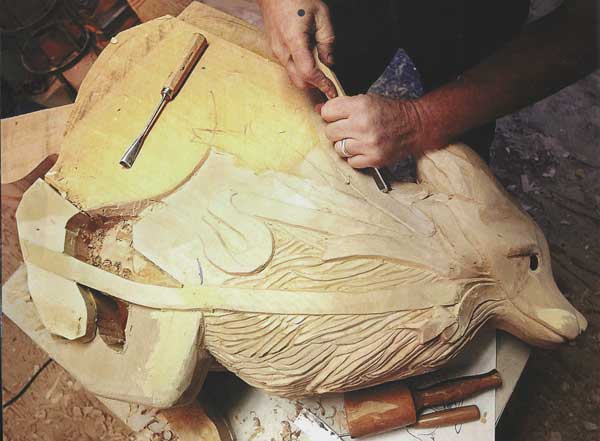 Scott carving a coyote. This piece took him over 4 months, just to give you an idea of the time frame. (Photo Courtesy of the Carousel of Happiness, James DeWalt, Tom Walker, and Kay Turnbaugh.)