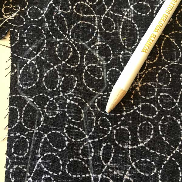 I know this is a little hard to see but I have traced the template onto the fabric in white. Next I will get a nice sharp pair of scissors and carefully cut out the tie shape.