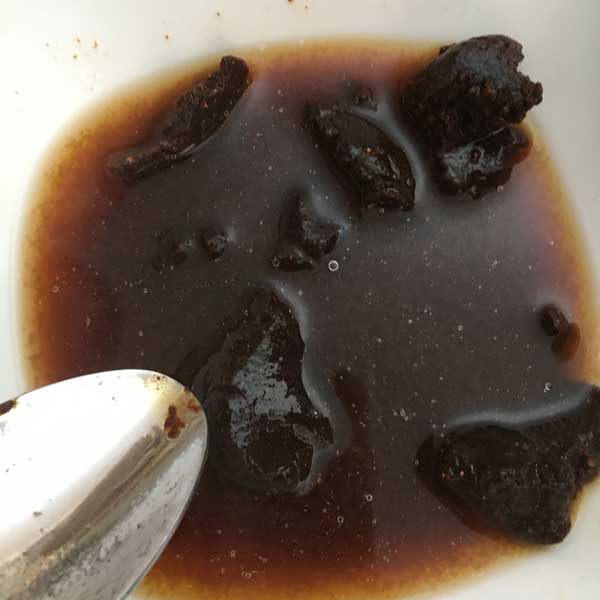 Dissolve the miso paste in 1/4 cup hot water.