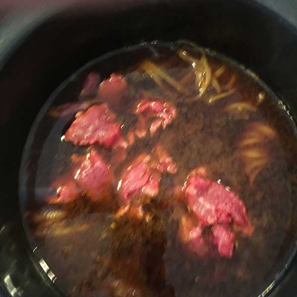 Here is a very blurry shot of the steak as it first went into the broth.
