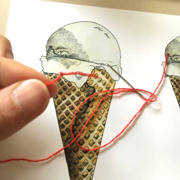With the needle threaded at the top, knot the other end.