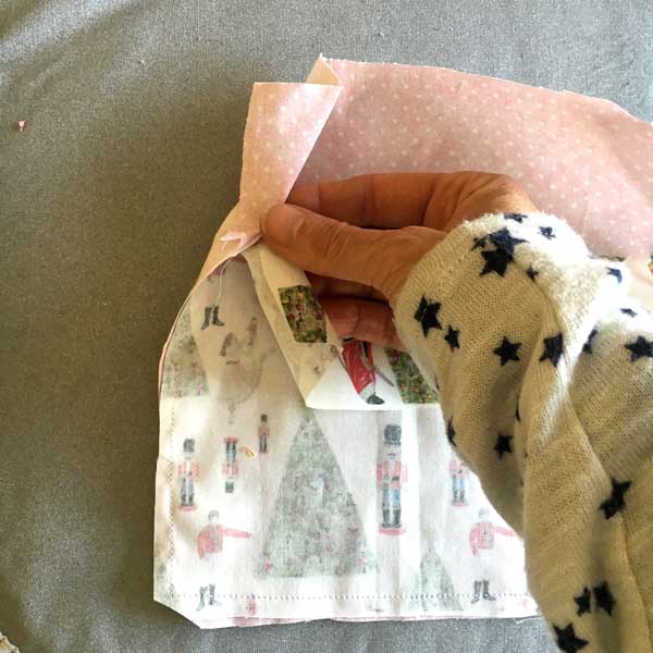 I opened one of the sides and will be sewing across the top of the two corners I just ironed out.