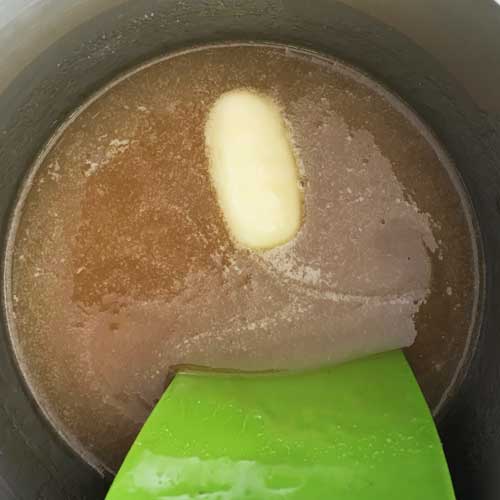 I am using a silicone spatula in the above picture. Never use plastic as it will immediately melt. Wooden spoons and metal work fine too.