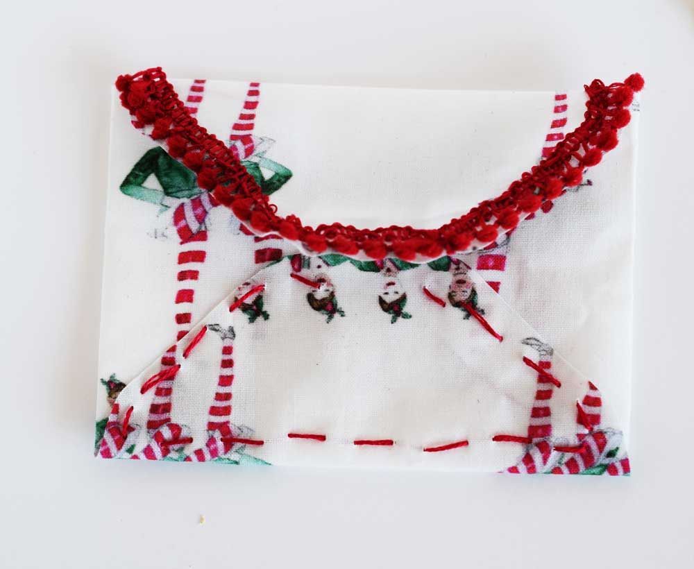 Above is an example using some embroidery to add a little detail and sew the bottom of the envelope closed. 