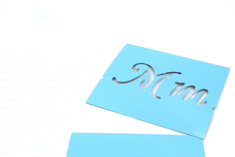 In the image above is a stencil to trace and some lined notebook paper.
