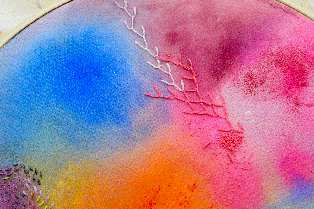 Now get your thread and needle and let your heart guide some stitches. Here I make some FEATHER STITCH , SEED STITCH , and FRENCH KNOTS . I just grabbed colors that looked "right" to me and began stitching.