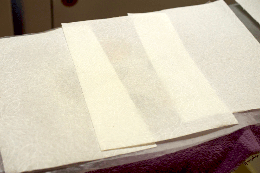 I put some paper towels down on top of the wax paper and ironed using a medium heat for a couple of minutes. I flipped the wax paper over and ironed the other side for a couple of minutes.