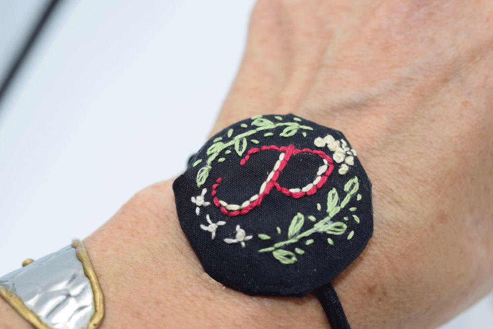Put a hair band in the loop on the back to make a bracelet or decorative hair tie.