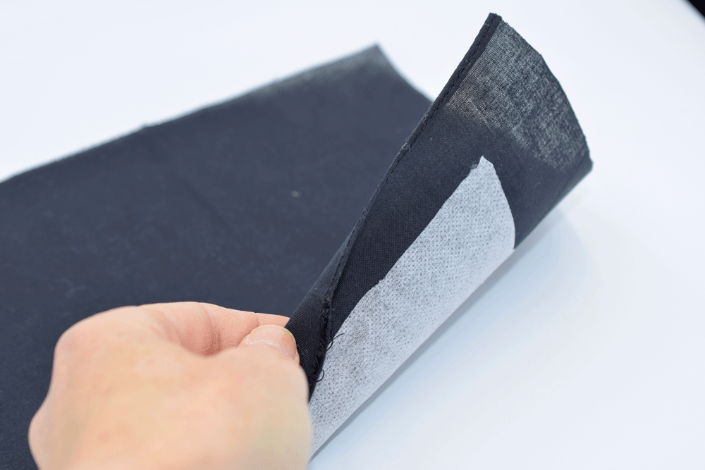 To add interfacing, just face the textured side towards the wrong side of the fabric . Run a warm iron over the fabric and the interfacing will adhere to the back of the fabric.