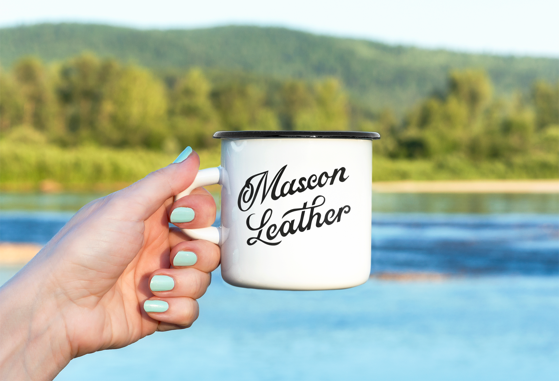 mockup-of-a-hand-holding-an-enamel-mug-behind-a-beautiful-landscape-m9247-r-el2.png