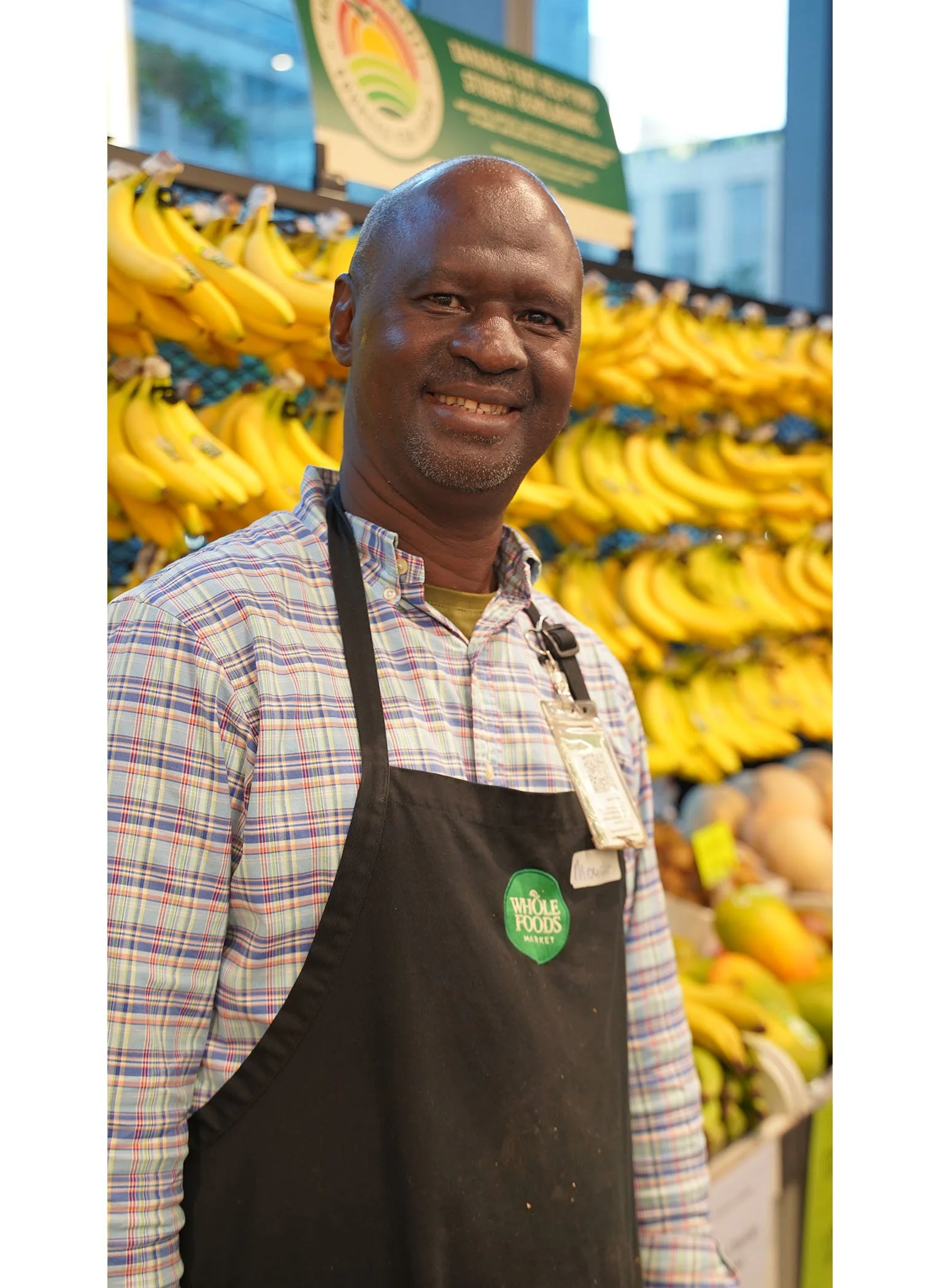Mouctar likes to swim! He has been working at Whole Foods for 5 years, and directed the photoshoot to get the best view of the bananas.