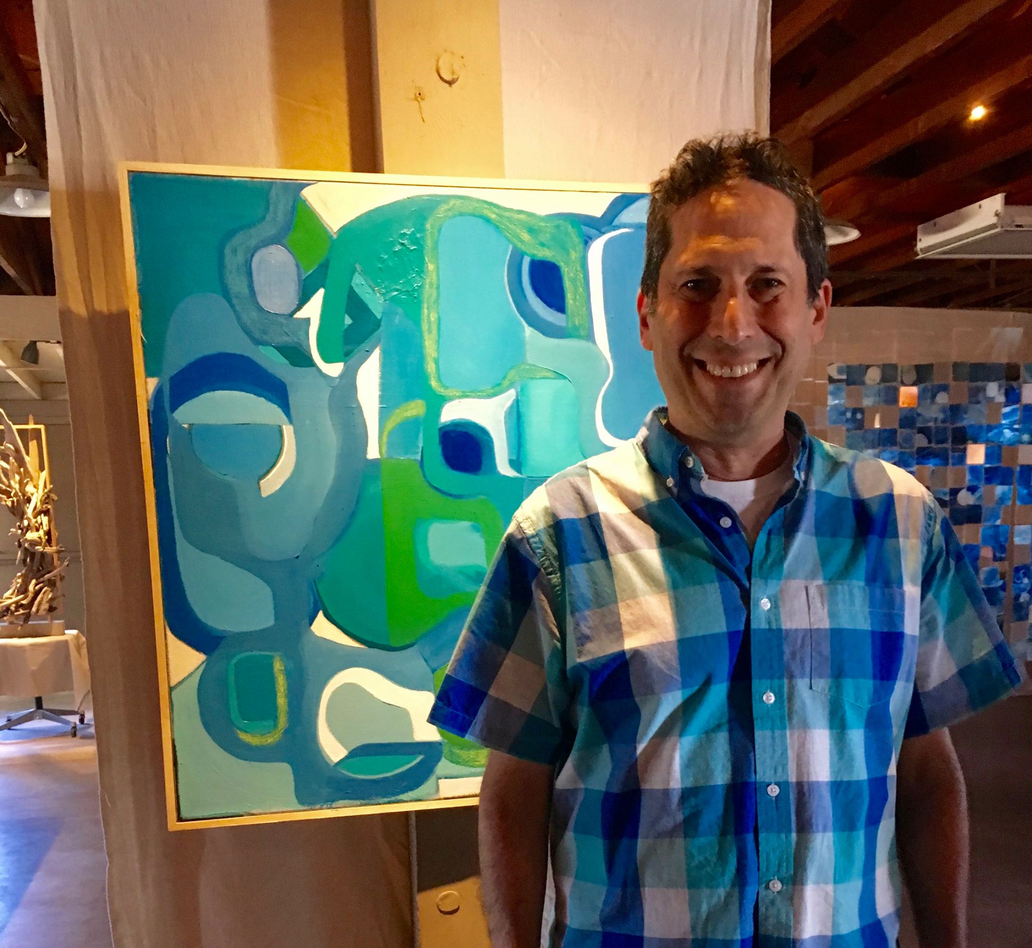 Jay Zaltzman a co-founder of Markerville in front of Pools and Lawns a 30x30 acrylic and oil on canvas painting