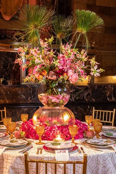 Architectural Digest. April, 2018 Natalie Kraiem "Inspired by the gorgeous flowers in Giverny, France, I created a tablescape with a floating garden and exotic flowers," explains Kraiem. A tablecloth in fabric from Kravet made a graphic foil to the romance of pink flowers and gold glassware.