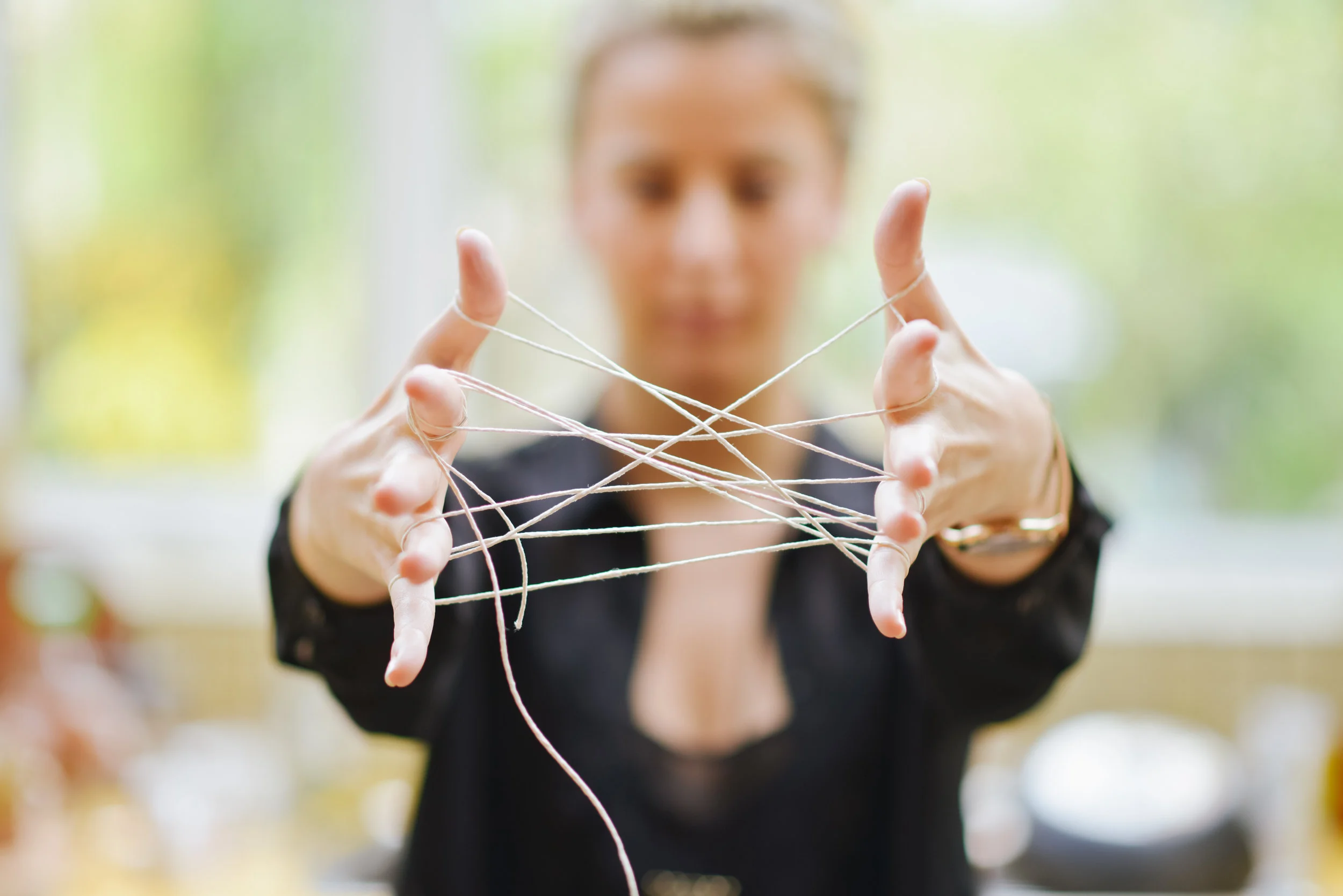 Womans hands connected With Tangled String.jpg