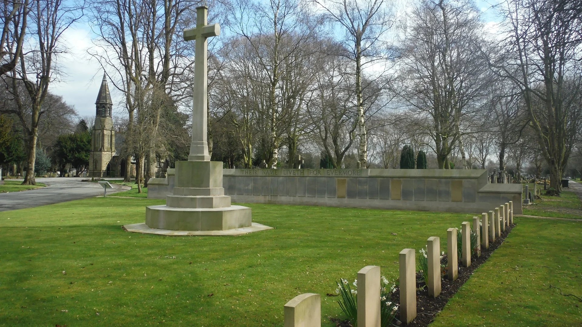 The memorial Screen wall behind the Cross of Sacrifice in Manchester Southern Cemetery
