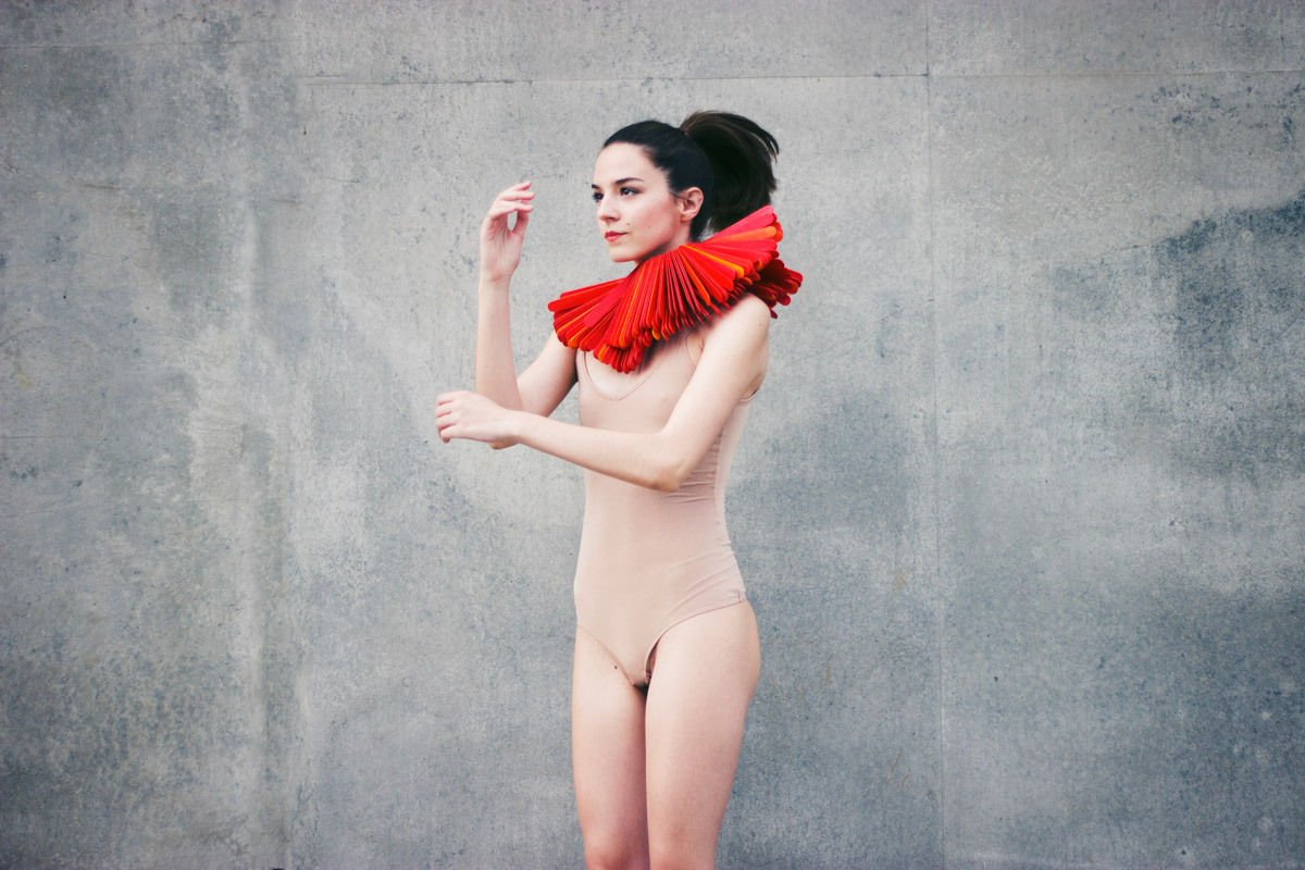 Model jumping against a grey background