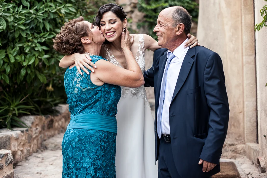 23_Destination_Wedding_in_Monemvasia_bride_parents_kiss.jpg