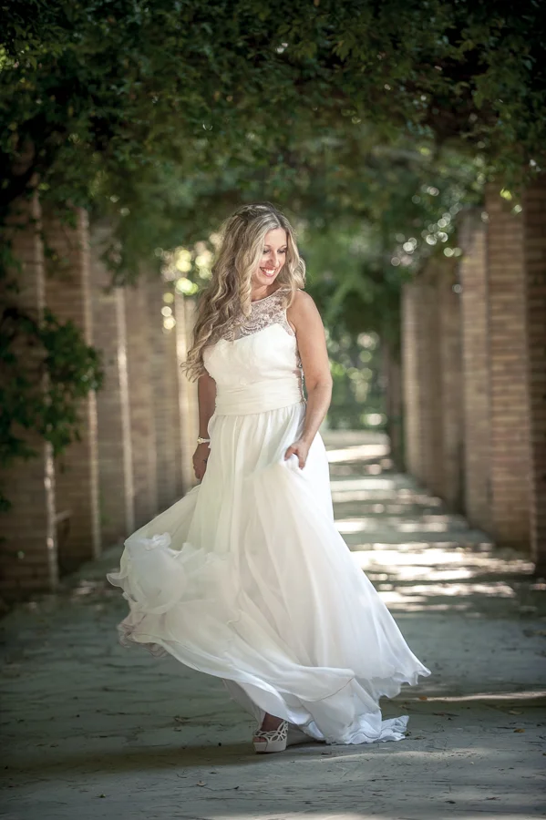 01_After_wedding_smiling_bride_flower_corridor_location_athens.jpg
