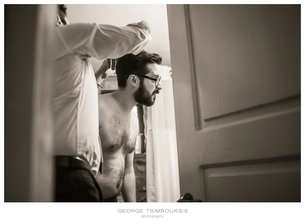 57_Wedding in Mystras_groom looking the mirror.jpg