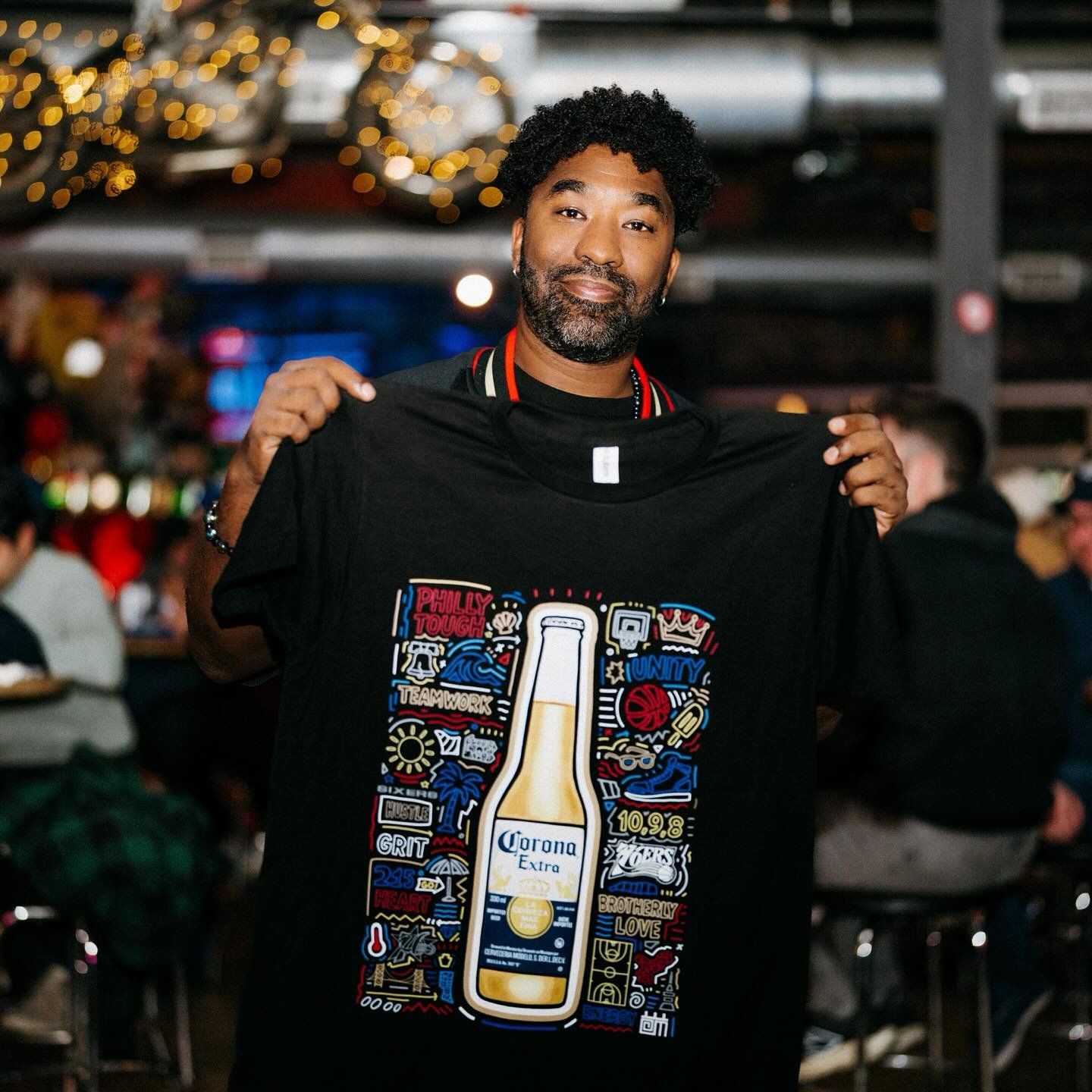 I&rsquo;m so proud of the t-shirt design that I created for the @sixers collab with @coronausa!  This limited-edition tee blends the heart of Philadelphia, the spirit of the 76ers, and the beach vibe of Corona. The shirt made its debut at the 76ERS B