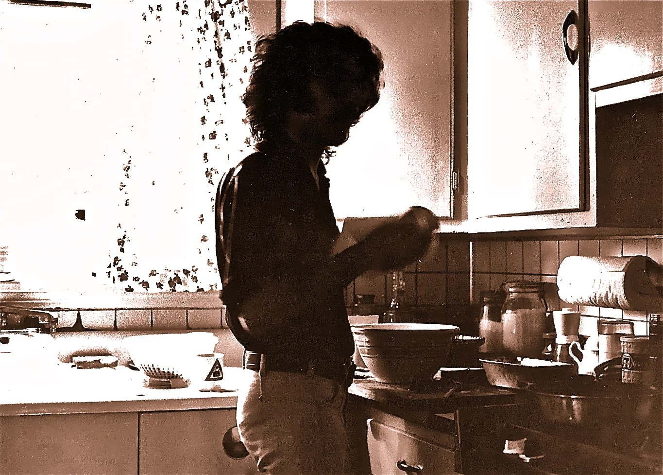 Photograph, captioned "My cousin in my kitchen," by Marcel Piron, 1975. Salt print on Arches aquarelle paper. (Portrait of Denis LaCloche.)
