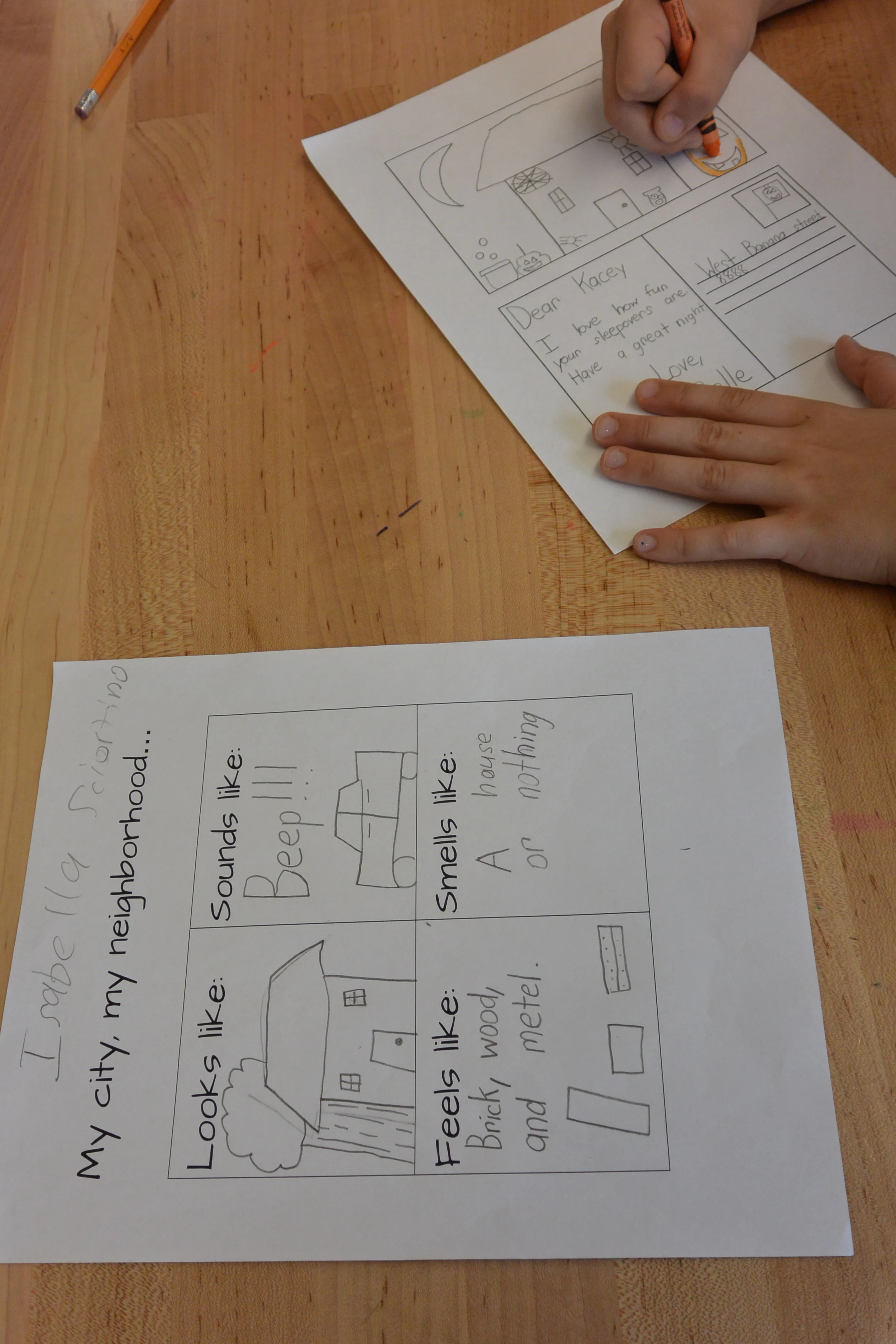 A student works on a sketch handout to design their postcard. 