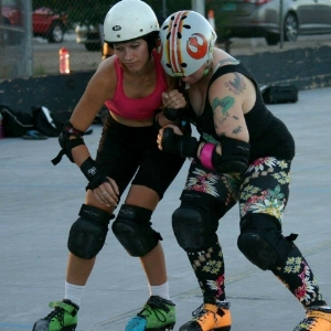 Ima Hazard practices with Madgina Dem Tatas in her hazard-cone-orange skates in 2015. 