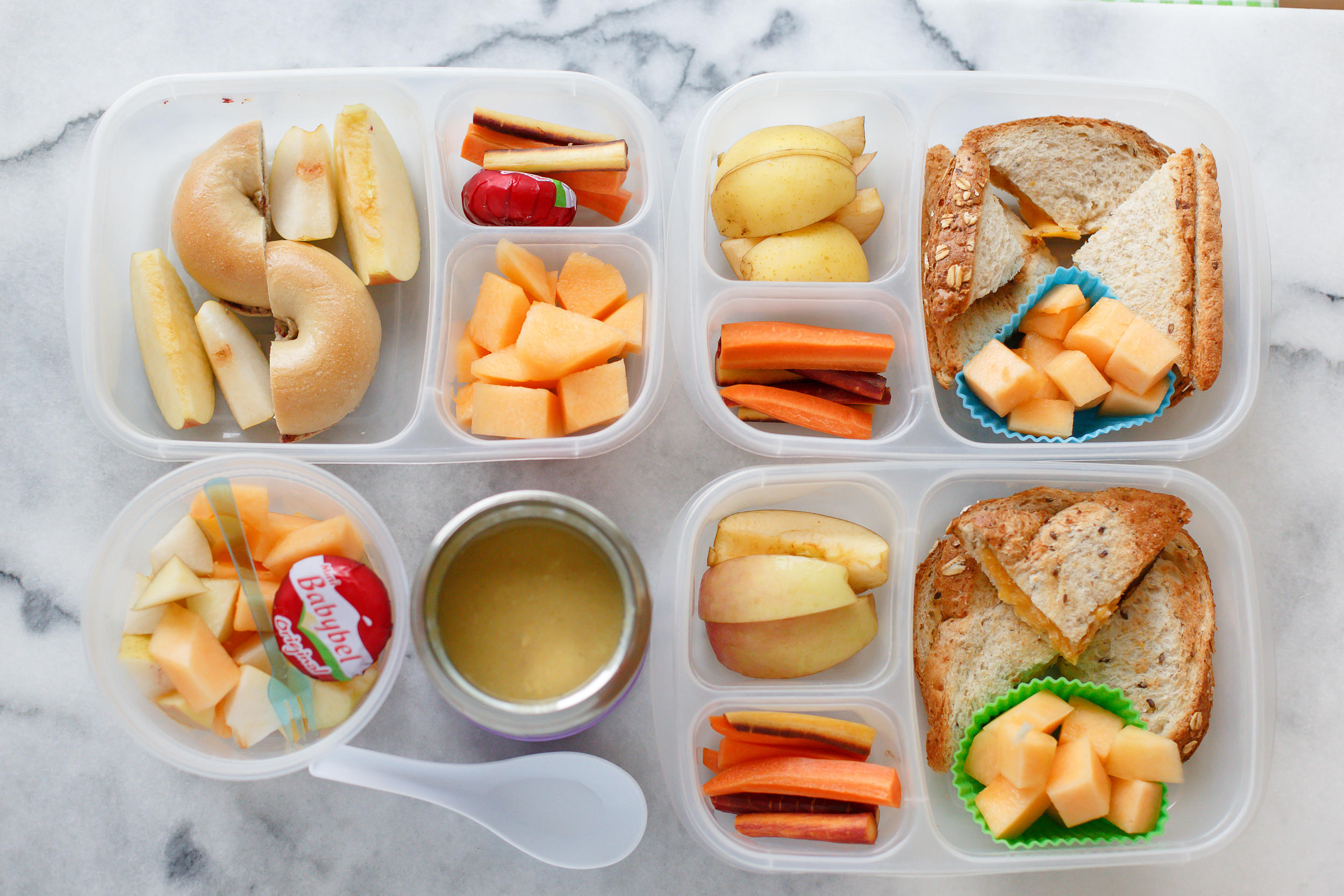 A little variety of leftovers from the weekend, for a Monday lunch. Two have toasted cheese sandwiches, with fruite and carrots. One has PB&J on a bagel, with fruit, carrots and cheese. And the fourth has leftover homemade chicken soup, fruit and cheese. 