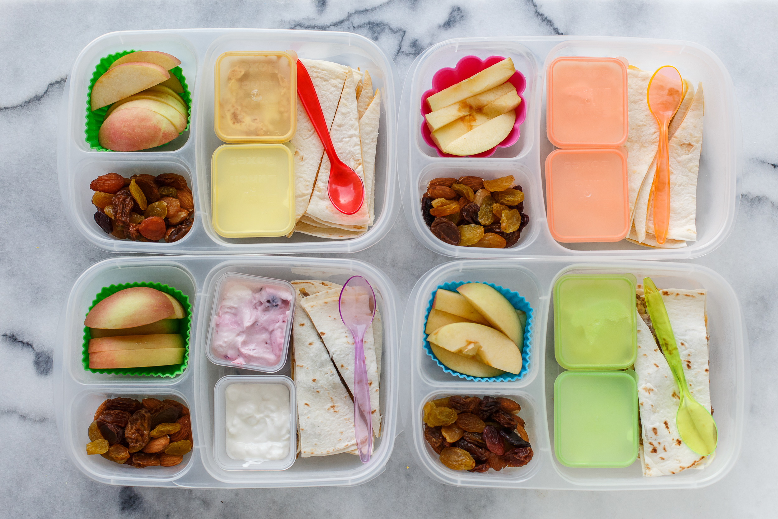 Quesadillas, two have meat in them, with sour cream for dipping. With apples, raisins, almonds, and yogurt for dessert.