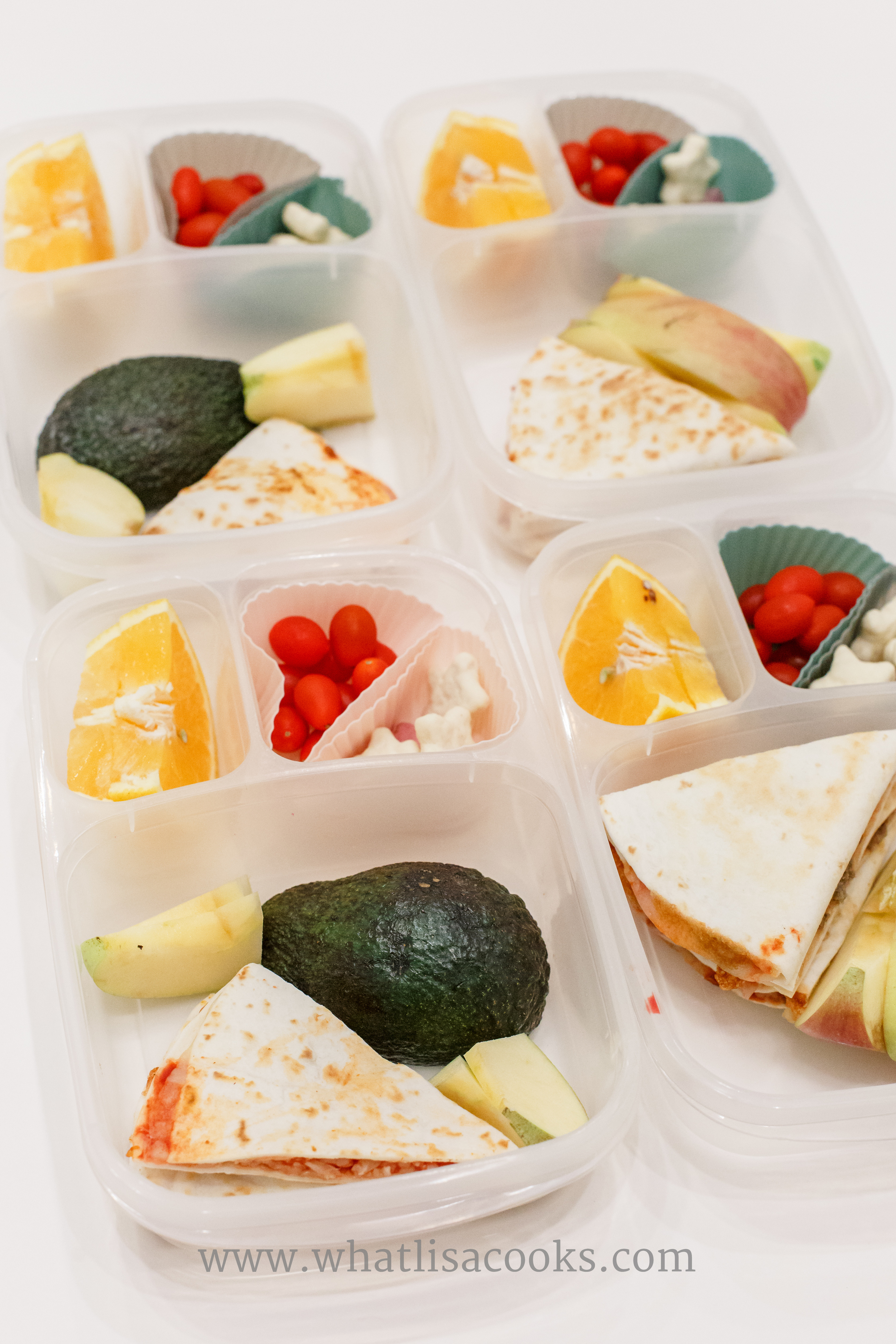 Pizzadillas: tortilla with mozzarella cheese and tomato sauce. With apples, avocado, tomatos, orange slices, and yogurt covered star cookies. 