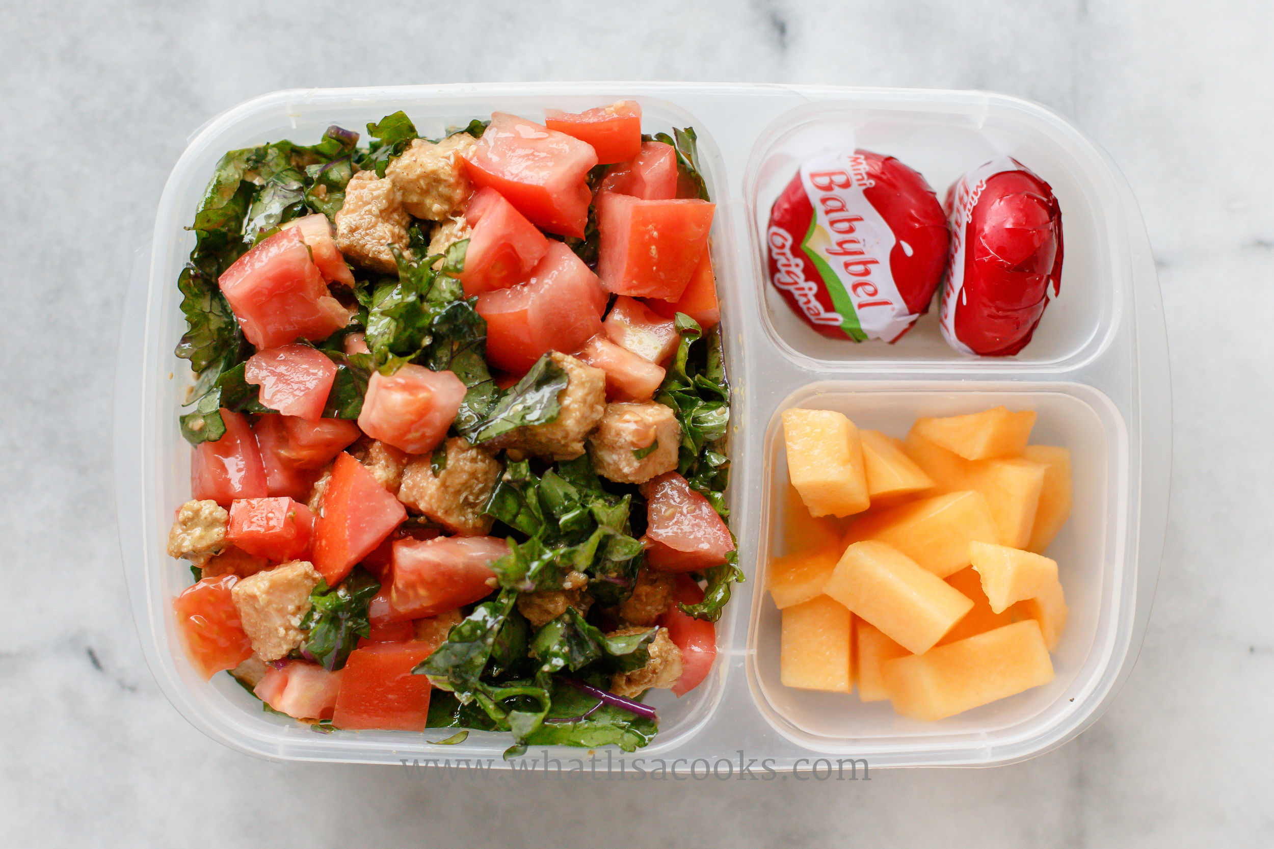 A quick and easy kale salad - just quickly tossed with sesame oil and Bragg's aminos. With diced tomatoes and bites of a leftover salmon burger. Melon and cheese on the side. 