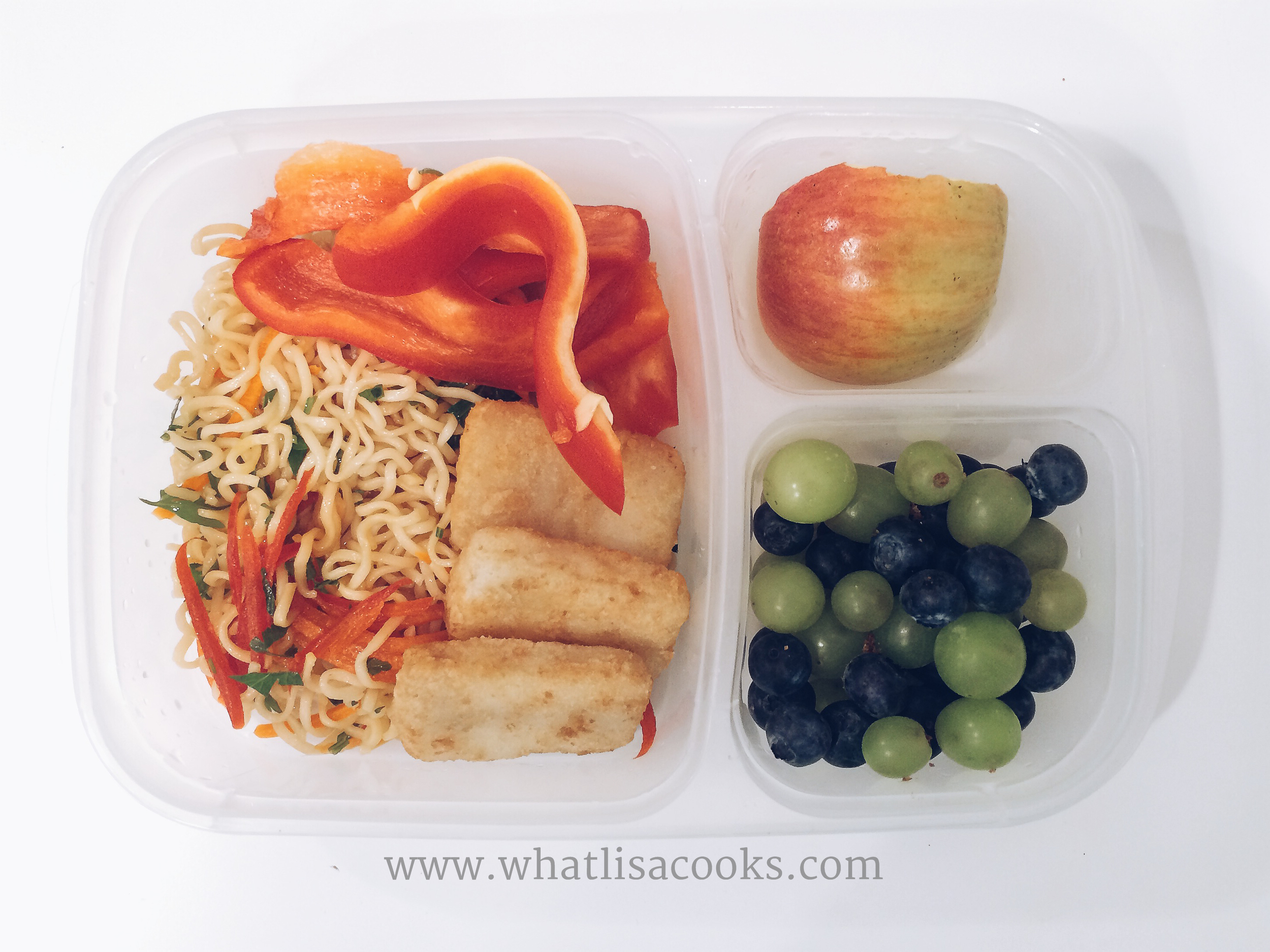 Dinner leftovers - seasoned ramen noodles with peppers, carrots and cilantro, a few pieces of baked fish, red peppers, apple, blueberries and grapes. 