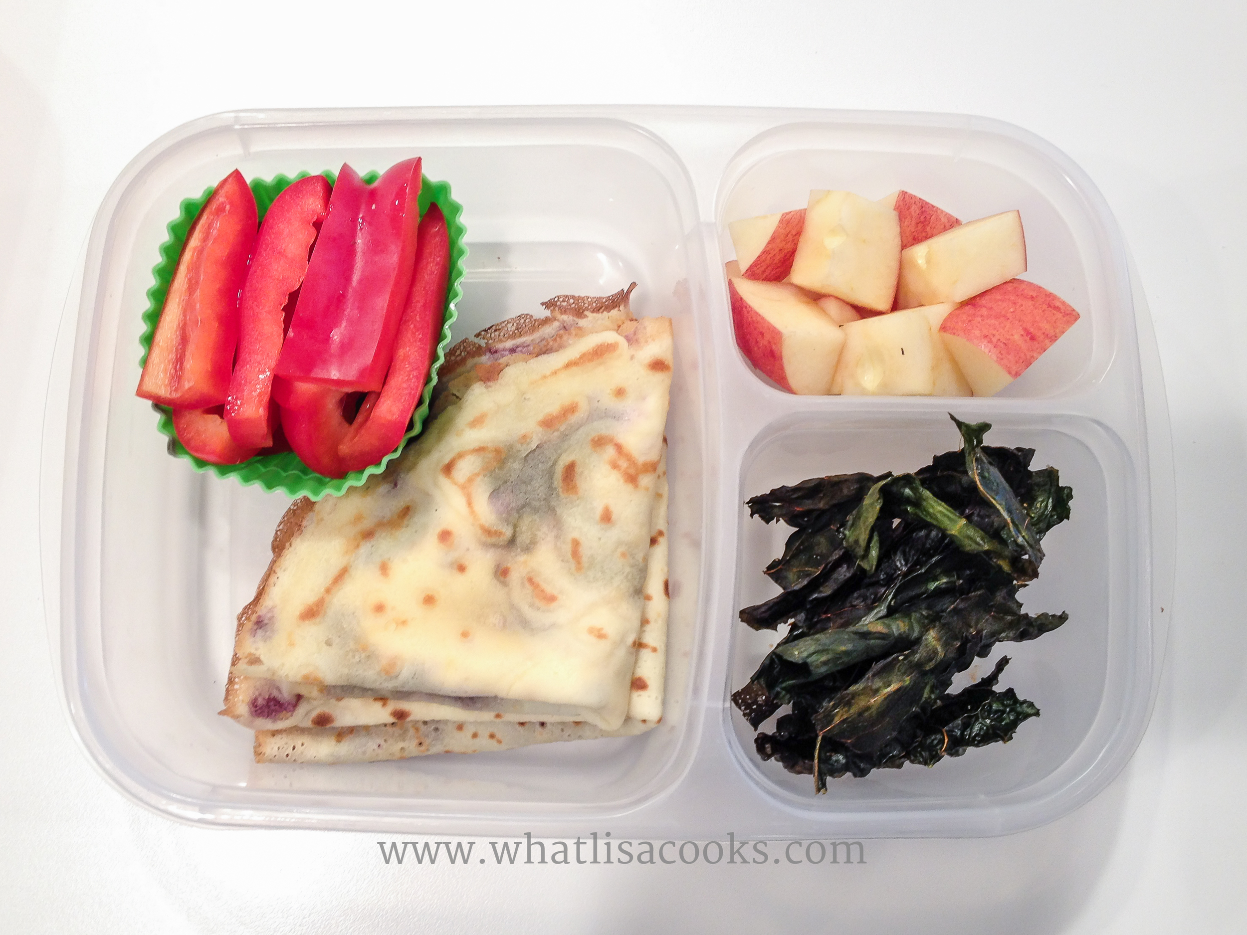 Homemade crepes leftover from a weekend breakfast, with cream cheese and jam, sweet red peppers, kale chips, apples