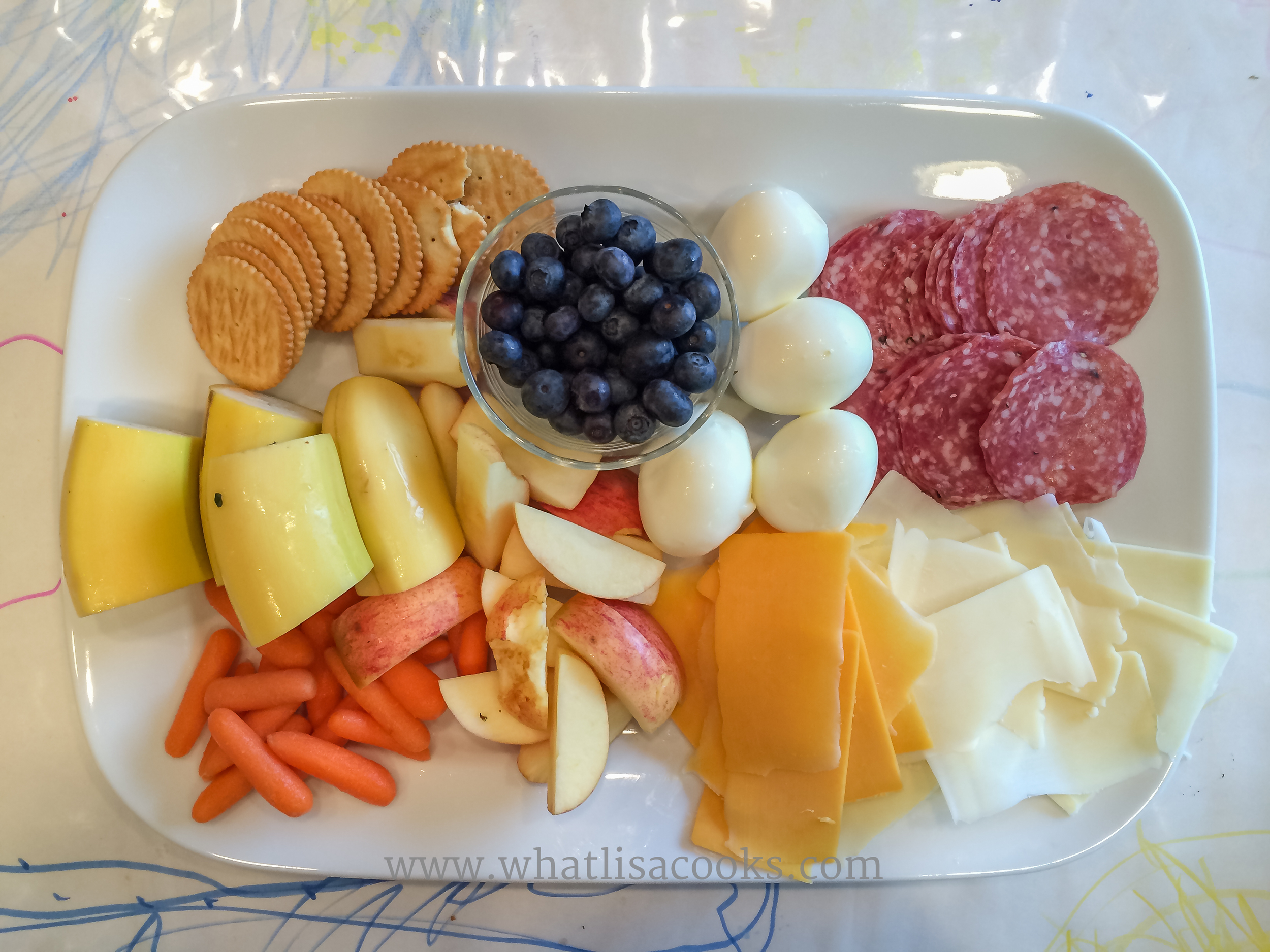 Apples, bananas, carrots, cheeses, salami, boiled egg, blueberries and a few crackers (that was all the crackers I gave for four kids to share).