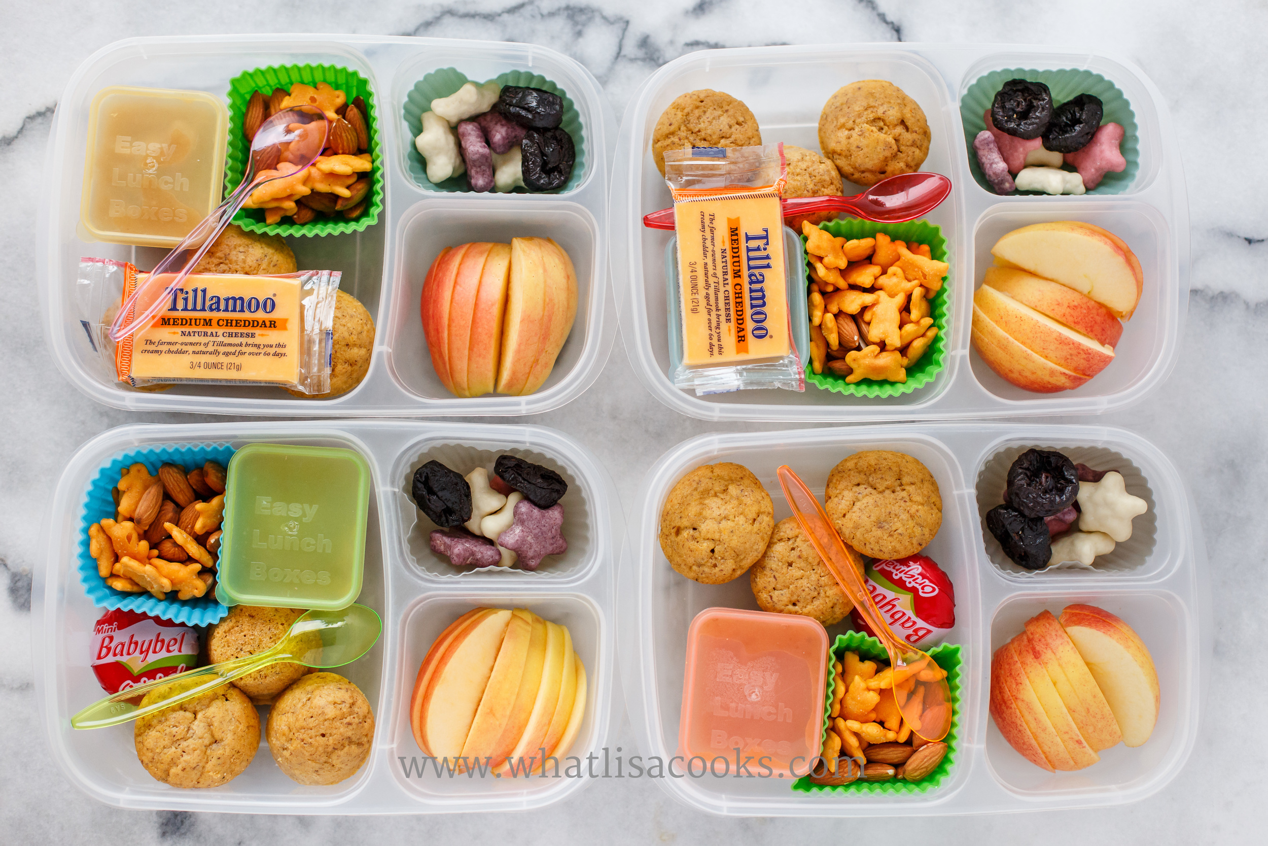 Muffins, cheese, applesauce, bunny crackers, almonds, apples, and yogurt covered cookies. 