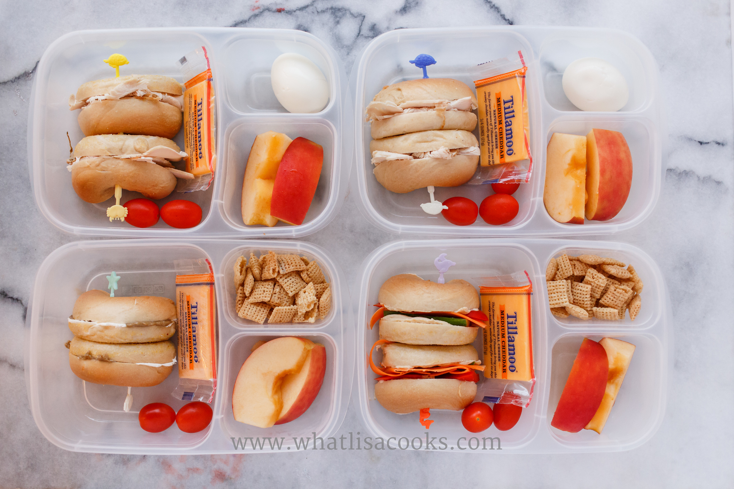 I was out of bread, so it was bagel sandwiches. Two have turkey and cream cheese, one has almond butter and cream cheese, one has hummus and veggies. They all have a cheese, tomatoes, apples, and rice chex. 