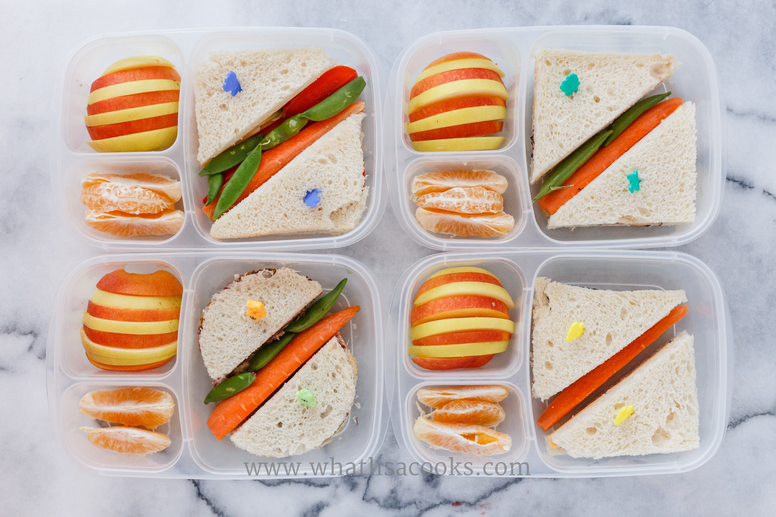 Simple sandwiches. One has sunbutter & jelly. one has ham, cheddar, and mayo. One has ham, cucumber, and cheddar. One has a veggie sandwich with peppers, cucumbers, carrots, and cheddar. With carrots and sugar snap peas on the side, and oranges and apples. Two different apples sliced and alternated sure was a simple way to make the lunches look a little extra special. 