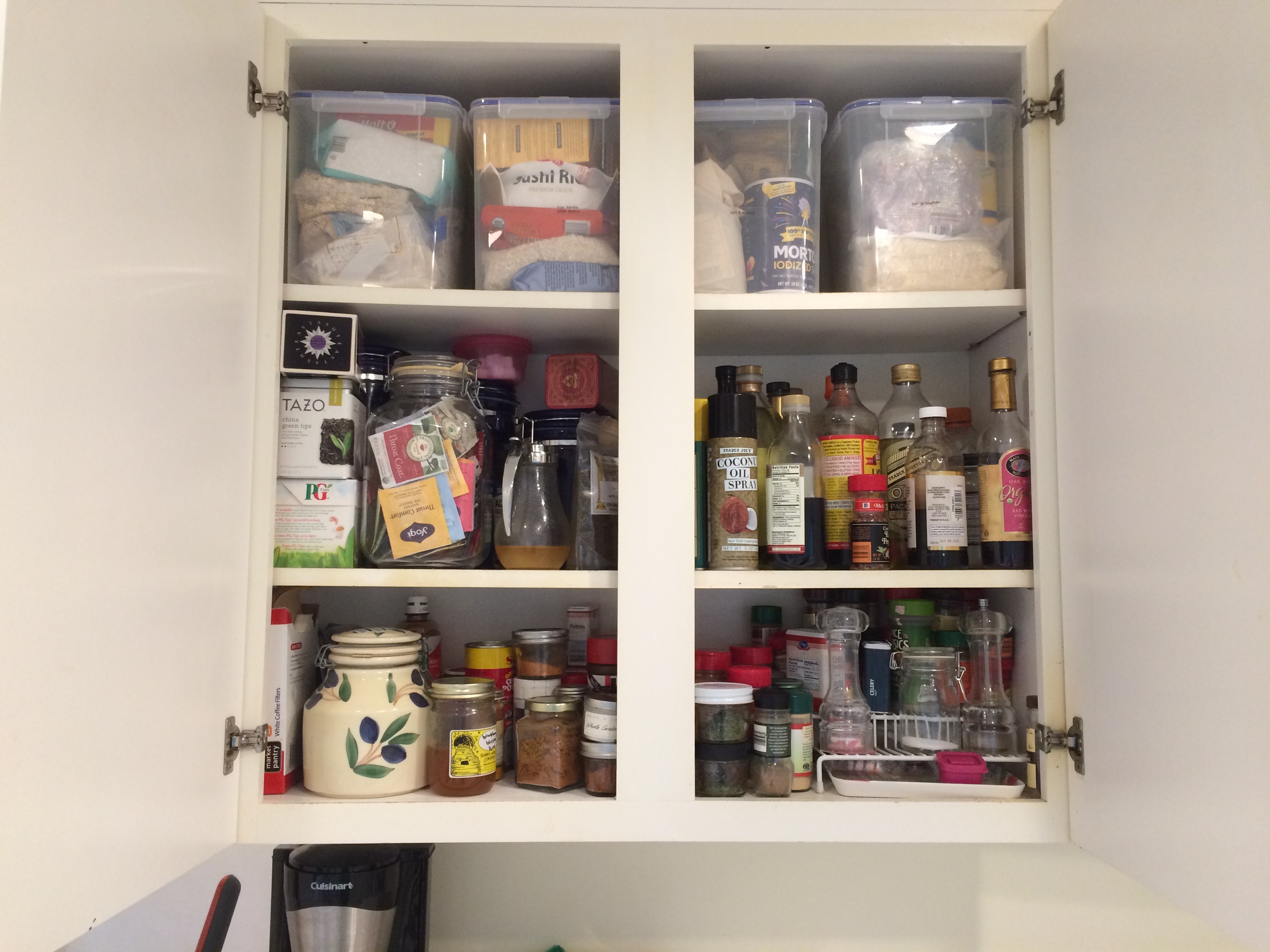 I have one upper cabinet to the left of the stove that has some cooking supplies - seasonings, oils, vinegars. The containers at the top have baking supplies, rice, hot cereals. And this is where we keep the coffee and tea. 