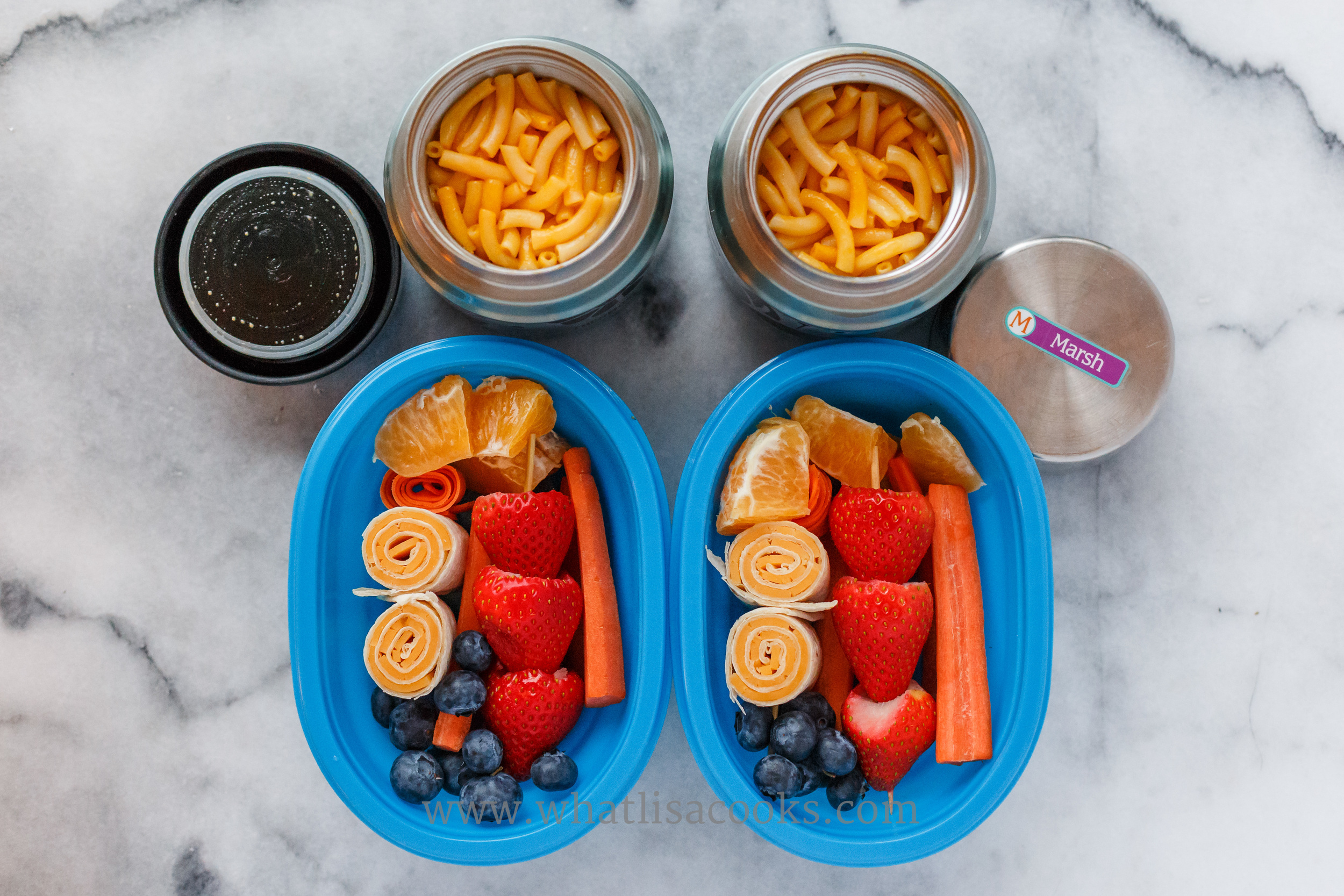 Leftovers for two: macaroni and cheese, tortilla and cheese rolls, with strawberries, blueberries, oranges, and carrots. You can never, ever go wrong with Mac & Cheese. 