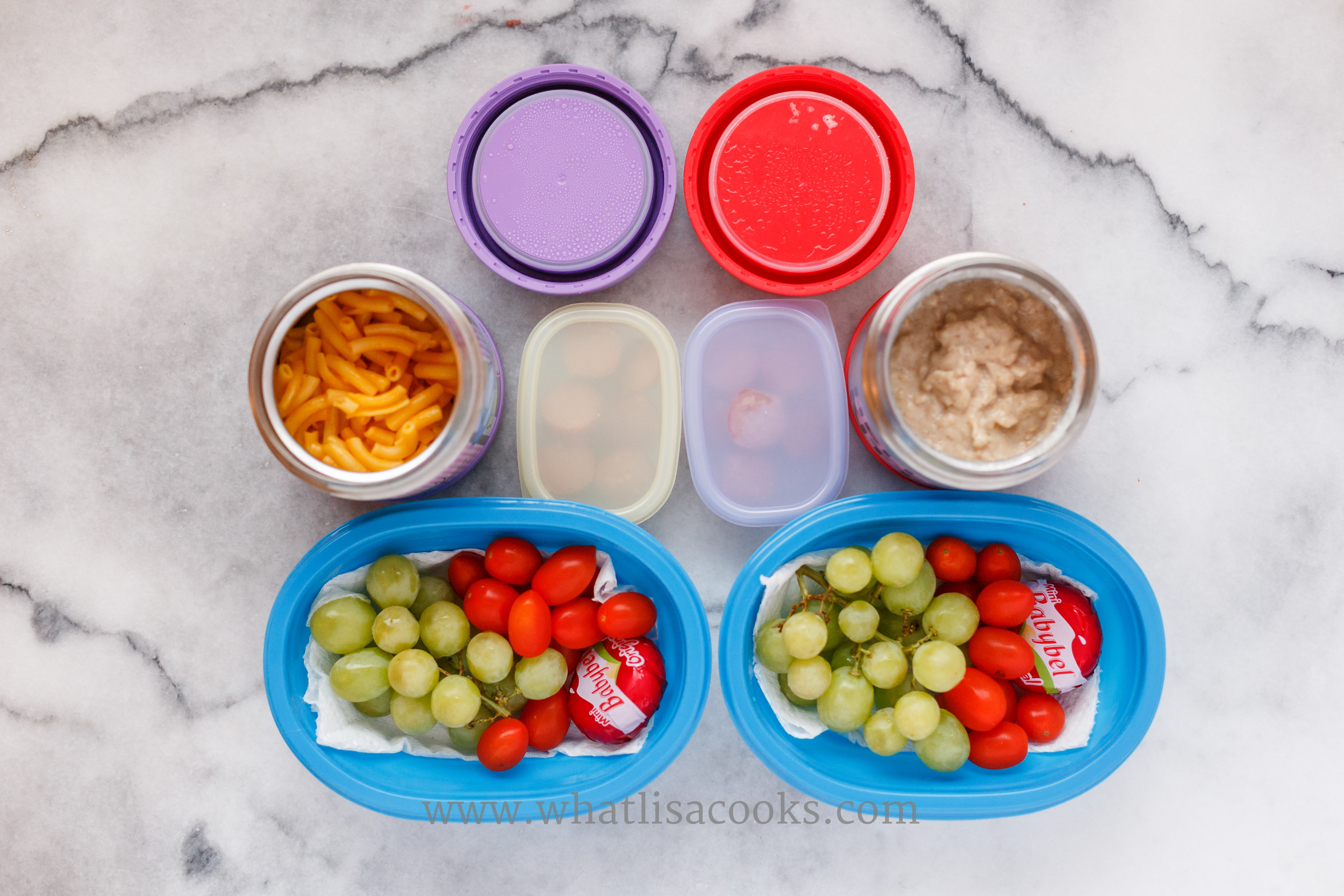 One has leftover macaroni and cheese, the other has my homemade instant oatmeal. On the side they have grapes, tomatoes, cheese, and a few bites of hot dog. They ate nearly every bite. 