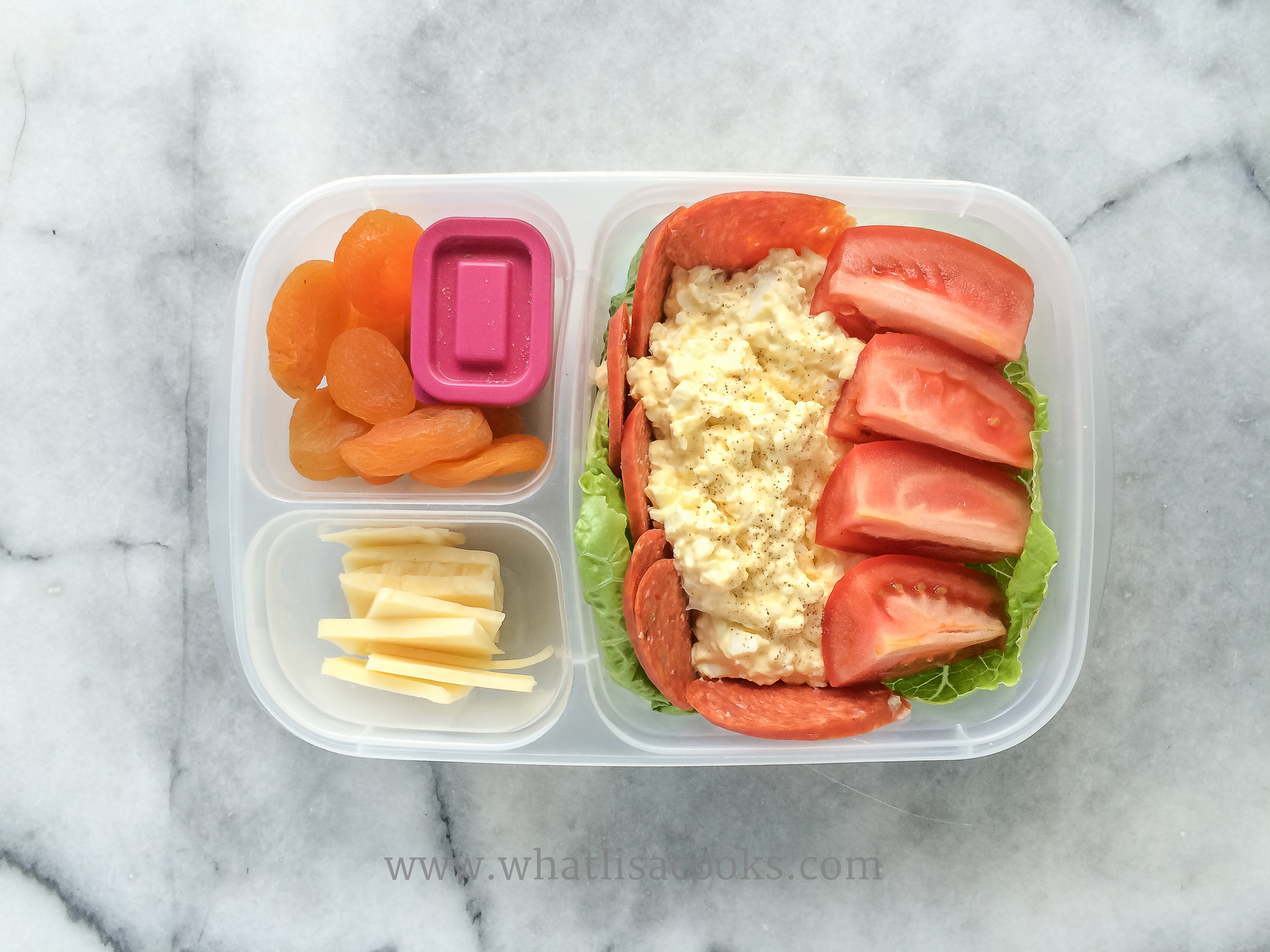 Egg salad, pepperoni, tomatoes, apricots, cheese. 