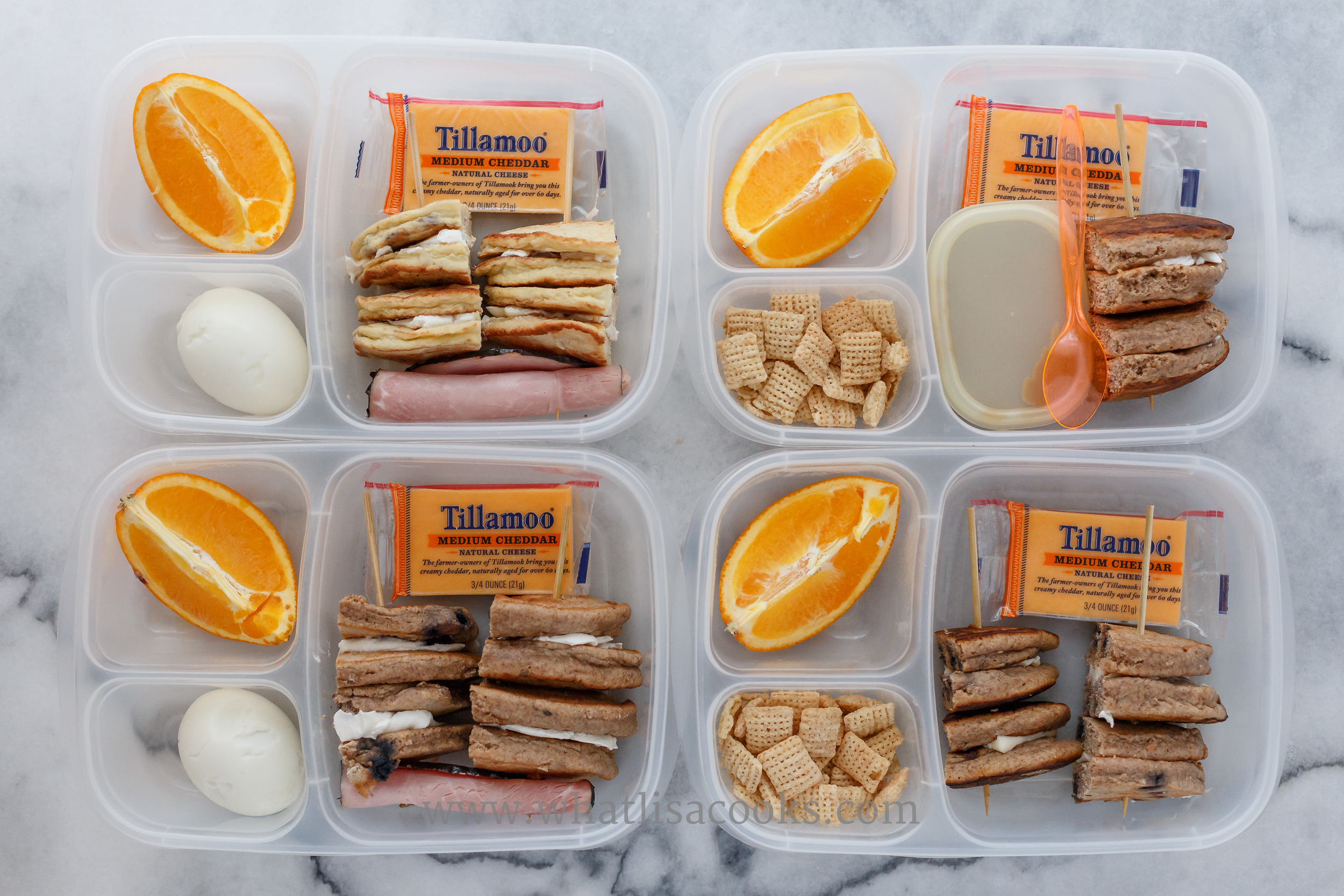 Breakfast for lunch: three have homemade whole wheat pancakes, one has potato pancake, filled with cream cheese or butter. Orange and cheese on the side. Two have boiled egg, one has rice chex, two have ham, one has sunbutter. 