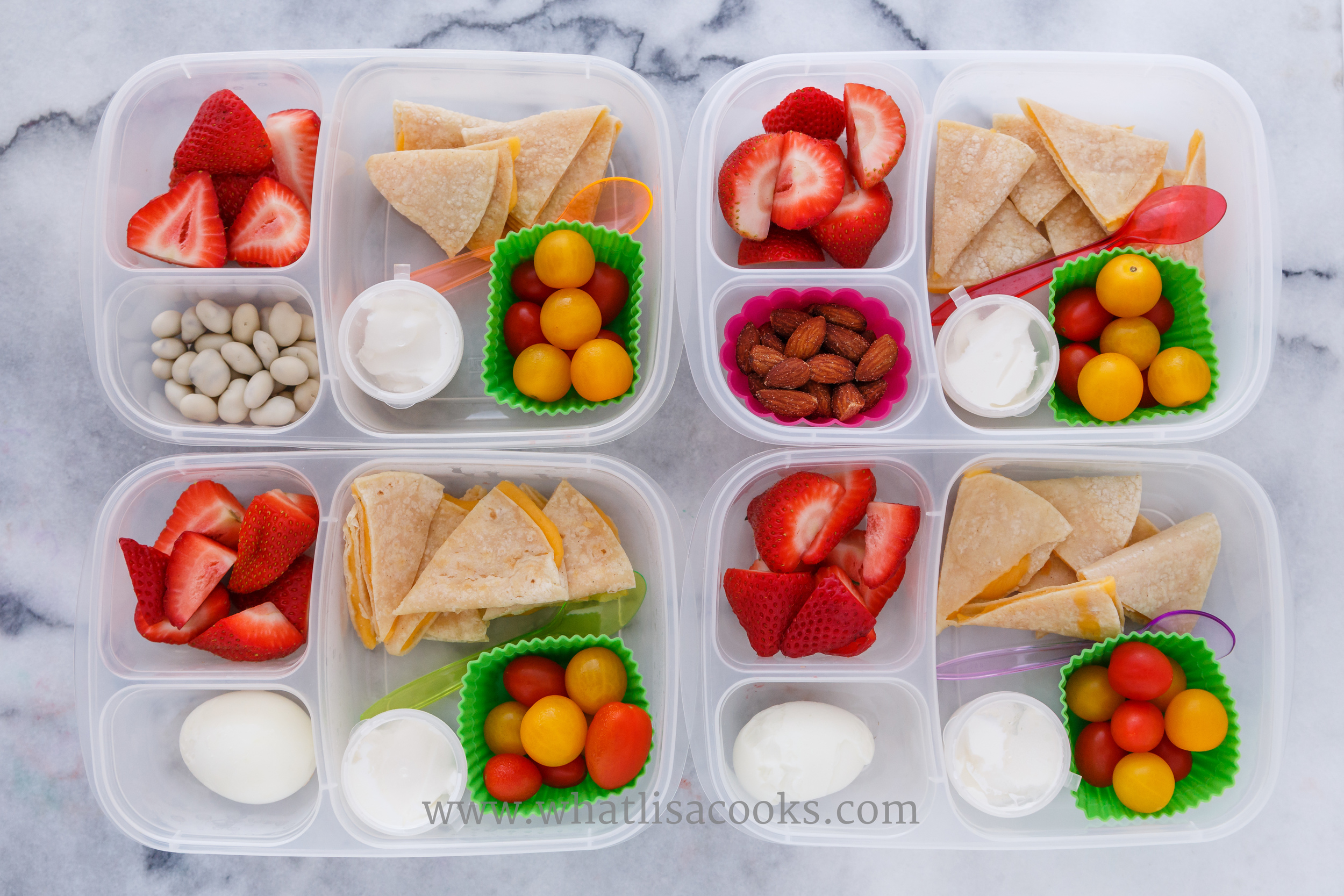 Quesadillas on gluten free corn tortillas, tomatoes, sour cream, strawberries. Two have a boiled egg, one has almonds, one has yogurt covered raisins. Packed in EasyLunchboxes, with silicon muffin cups and these dip cups . 