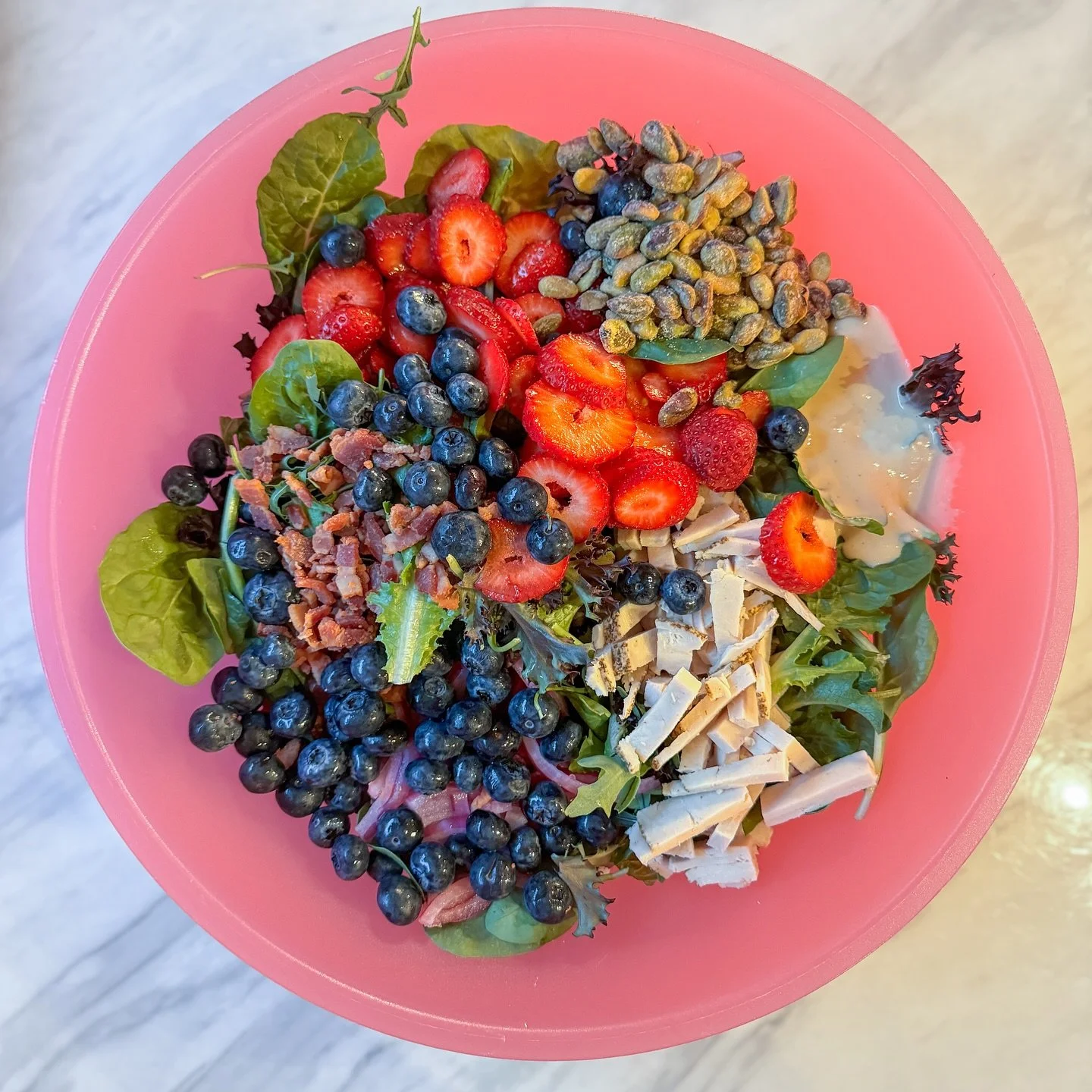 Still here with my salad obsession. This one has @earthboundfarm herb salad, which is their spring mix plus a bunch of fresh herbs, strawberries, blueberries, pickled red onion, @wonderfulpistachios salt and vinegar pistachios, turkey, bacon, and a l