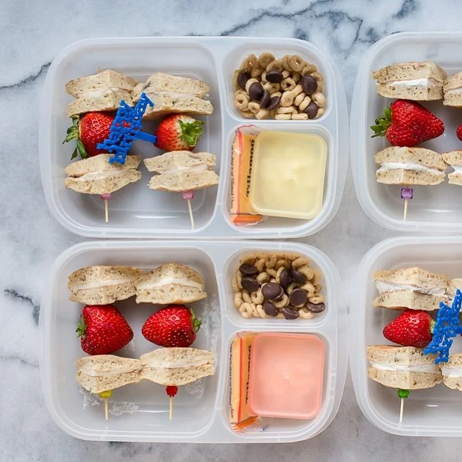 Here&rsquo;s another really simple birthday lunch for you. This one is pancake sandwiches (one of my favorite breakfast-for-lunch ideas!) cut in quarters on a fun little cocktail pick (because kids love food on sticks!) with a strawberry. On the side