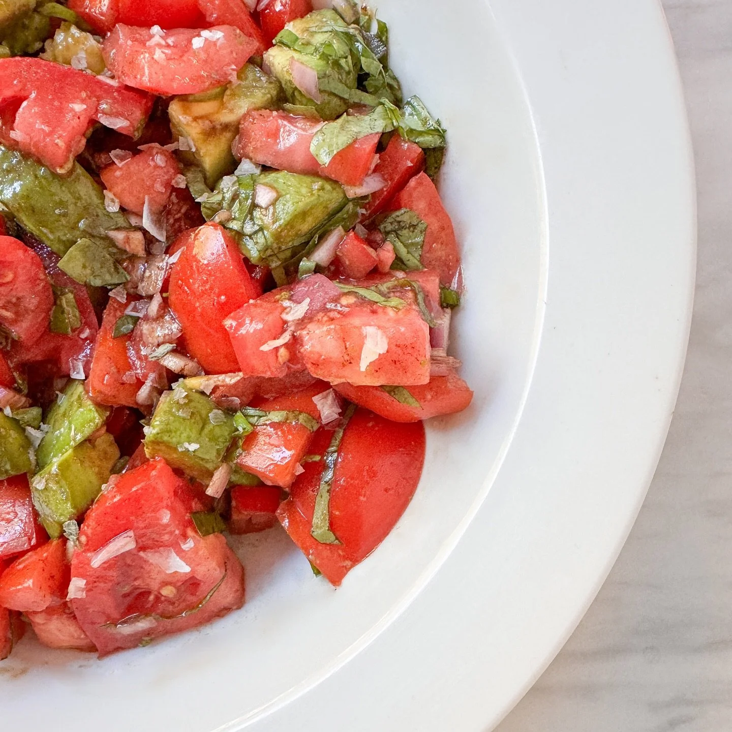 Tomato &amp; avocado salad, with tomatoes and basil from the garden, diced shallot, balsamic vinegar, lemon olive oil, and some big flakes of salt.